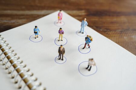 Social distancing. Miniature people stay apart to reduce Covid 19 virus infection. Maintain social distance Detained, could not find anyone. using as background Healthcare concept and keep distance.の写真素材