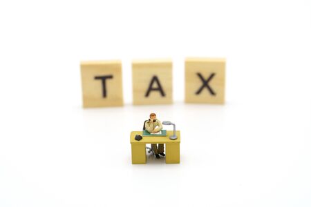 Miniature people Pay queue Annual income (TAX) for the year on calculator. using as background business concept and finance concept with copy space  for your text or  design.の写真素材
