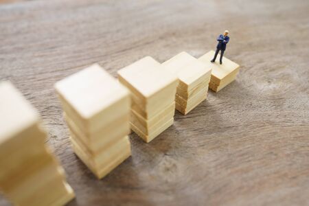Miniature people  businessmen standing Investment Analysis Or investment. The concept of being the number one business in the world stands at its peak.の写真素材