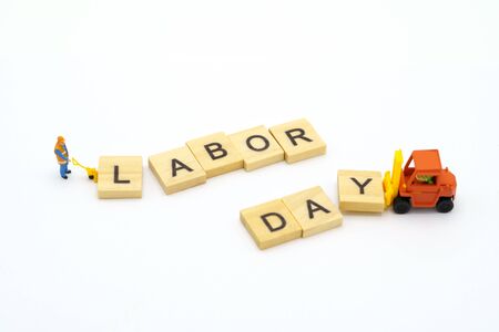 Miniature people standing with wood word Labor Day using as background Universal day concept and Health Day concept with copy space  for your text or design.の写真素材