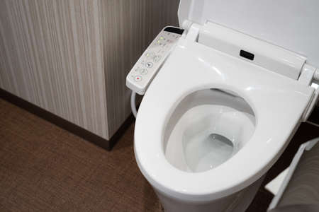 TOKYO, JAPAN - April 1, 2019: Modern high tech toilet with electronic bidet in Japan. Industry leaders recently agreed on signage standards for Japanese toilet bowls.のeditorial素材