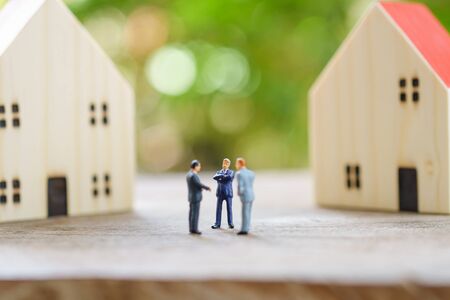 Miniature businessmen standing Investment Analysis Housing Or investment in movable property. using as background business concept and real estate concept with copy space for your text or design.の写真素材