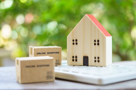 Online shopping with a shopping cart and shopping boxes delivery service using as background shopping concept and delivery service concept with copy space  for your text or  design.の写真素材