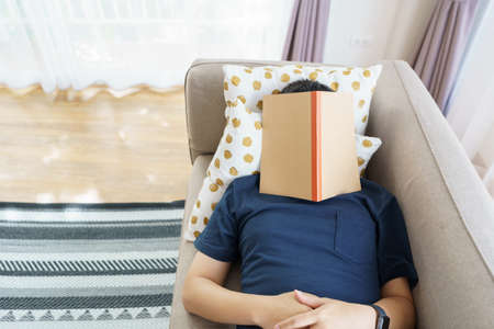 Asian handsome man Read books while sleeping. Man book cover Drowsiness causes sleep.The concept of...