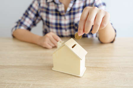 Business  Put the coin in House style piggy bank To save money, save money on investments, spend money when needed And use in the future. Investment concept. Savings with copy spaces.の写真素材