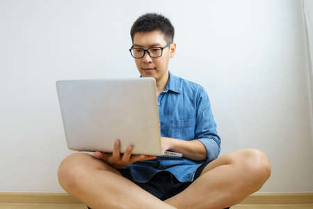 young Freelancer or Businessman working at home office with a laptop computer