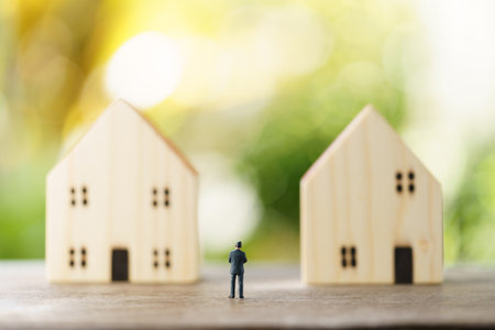 Miniature businessmen standing Investment Analysis Housing Or investment in movable property. using as background business concept and real estate concept with copy space for your text or design.の写真素材