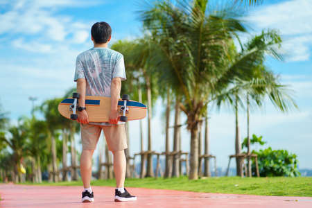 Hello Summer Surfers people Asian having fun with surfboards or surf skate around city streets background on a summer day. Free relax lifestyle and millennial trend conceptの写真素材