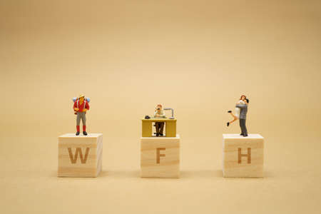 Work from home. Miniature people stay apart to reduce  virus infection. Maintain social distance...