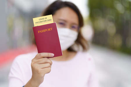 Passport with vaccination certificate for COVID-19 person record card. Immune passport or certificate for Get vaccinated before travel. Vaccination, disease immunity passportの写真素材