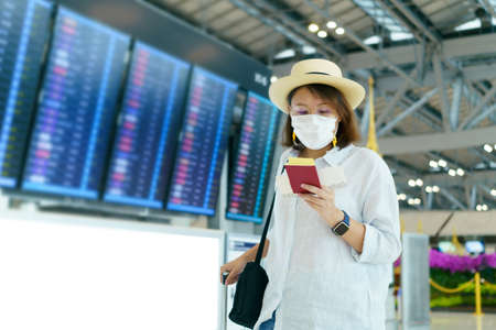 New Normal tourist wearing face mask is traveling on The airport . Social distancing healthcare system ,stay safe and Travel bubble concept.の写真素材