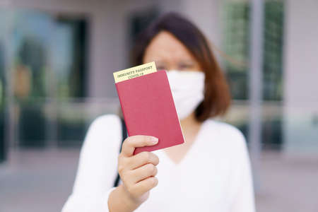 Passport with vaccination certificate for COVID-19 person record card. Immune passport or certificate for Get vaccinated before travel. Vaccination, disease immunity passportの写真素材