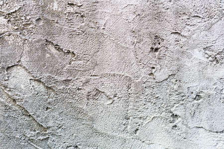 Loft-style plaster walls, gray, white, empty space used as wallpaper. Popular in home design or...