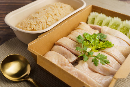 Hainanese Chicken rice (Singapore chicken rice) famous singapore food and Thai food on dark wood table. Asian food style.の写真素材