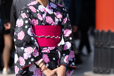 Young girl wearing Japanese kimono standing in front of Sensoji Temple in Tokyo, Japan. Kimono is a Japanese traditional garment. The word "kimono", which actually means a "thing to wear"の写真素材