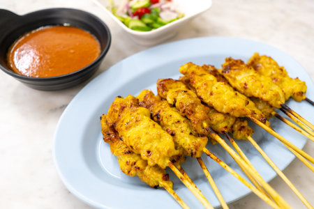 Pork satay or Grilled pork served with peanut sauce or sweet and sour sauce - Asian food Concept style Thai food on white background.の写真素材