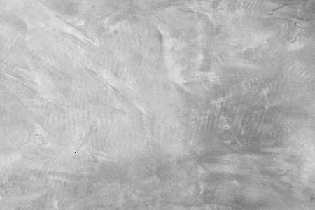 concrete wall with a raw, unfinished look showcases the rough texture of the material. The minimalist design highlights the industrial feel, with visible seams and natural imperfections adding character and depth.の写真素材