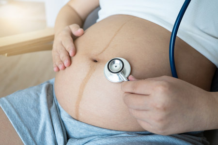 Expectant mothers often use a doctorâs stethoscope to listen to their babyâs heartbeat. This special moment deepens the emotional bond, creating a sense of closeness and anticipation for the birth.の写真素材