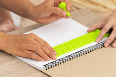 Creating Braille for visually impaired individuals involves carefully crafting raised dots that form tactile symbols, enabling them to read and access information independently.の写真素材