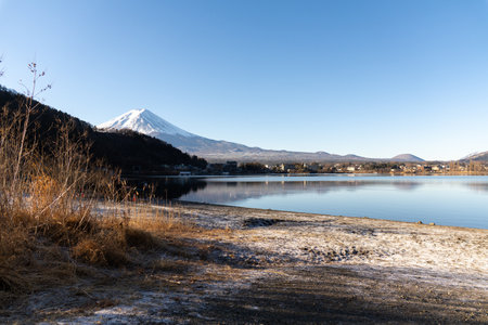 A breathtaking view of Mount Fuji, standing majestically above serene landscapes, with its iconic snow-capped peak and ever-changing seasonal beauty.の写真素材