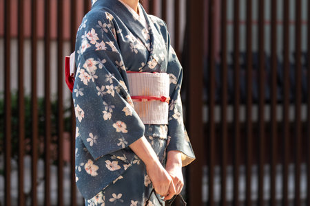 Young girl wearing Japanese kimono standing in front of Sensoji Temple in Tokyo, Japan. Kimono is a Japanese traditional garment. The word "kimono", which actually means a "thing tの写真素材