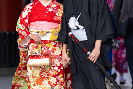 Young girl wearing Japanese kimono standing in front of Sensoji Temple in Tokyo, Japan. Kimono is a Japanese traditional garment. The word "kimono", which actually means a "thing to wear"の写真素材