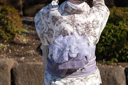 Young girl wearing Japanese kimono standing in front of Sensoji Temple in Tokyo, Japan. Kimono is a Japanese traditional garment. The word "kimono", which actually means a "thing to wear"の写真素材