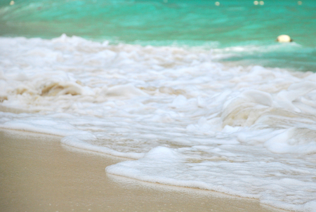 The wave from the green sea on yellow sands.Selective focus.の写真素材