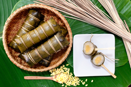 Glutinous rice steamed in bamboo bowl on banana leaf .の写真素材