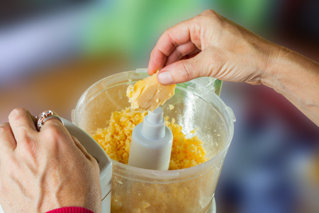 Hand working on food processor-Rub hand at cheese
