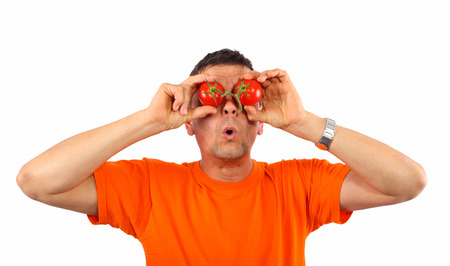 Man with tomatoes on his eyesの写真素材