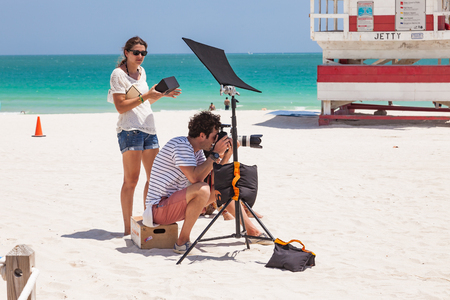 Miami, USA - April 8, 2013: Photographer and his assistant at photoshooting in South Beach-Miamiのeditorial素材