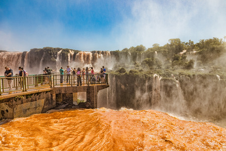 Foz do Iguacu, Brazil - November 20, 2017: People on a footbridge in the middle of the Iguazu waterfalls on the brazilian side.のeditorial素材
