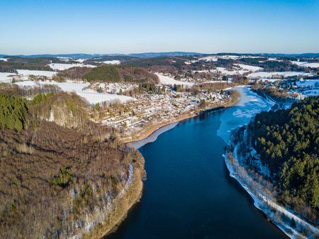 Aerial view of the partially frozen Lingese dam (Lingesetalsperre)near Marienheide in winter.の写真素材