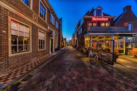 Enkhuizen, The Netherlands - May 04, 2019: Old street in Enkhuizen at the IJsselmeer in the Netherlands during dusk.のeditorial素材