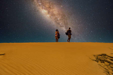 A man and a woman at the desert horizon.