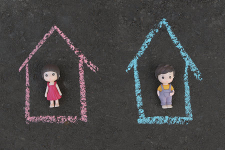 Toys of boy and girl lie on dark background in their houses. concept of gender separate education of sexes.の写真素材