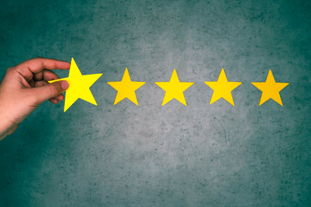 Hand of putting increase five star shape. Best excellent business services rating customer experience concept. Green textured background.の写真素材