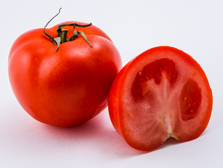 Isolated red tomato on a white backgroundの写真素材