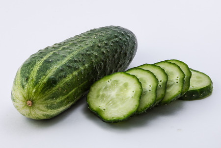 Isolated green cucumber on a white backgroundの写真素材