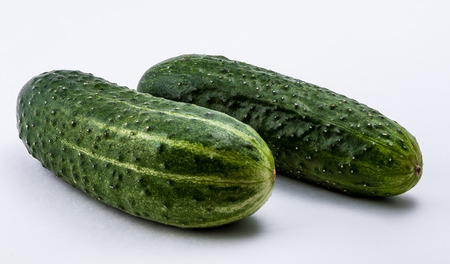 Isolated green cucumber on a white backgroundの写真素材