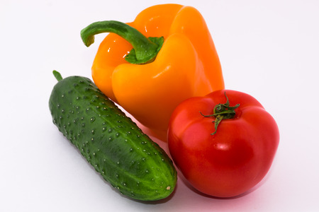 pepper, cucumber and tomatoes on a white backgroundの写真素材