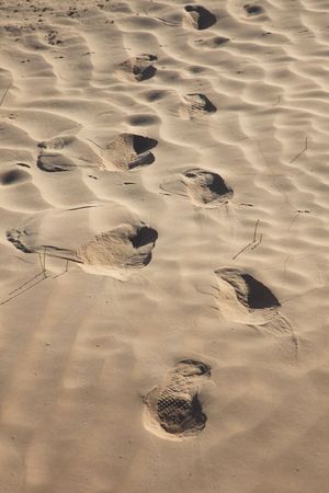 Human trace of a foot on yellow sandの写真素材