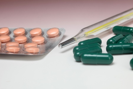 Close-up medical thermometer and pillsの写真素材