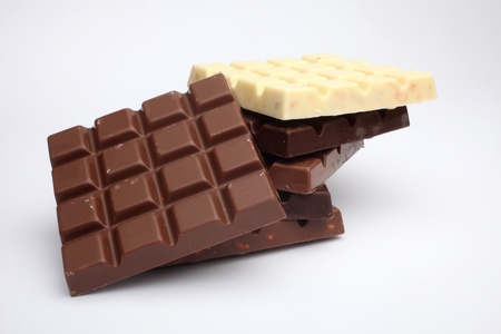 Close up of chocolate pieces on white background 