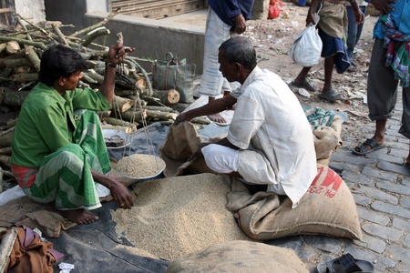 KUMROKHALI, INDIA - JANUARY 12: Man selling rice at a street stall outside the market in Kumrokhali,...
