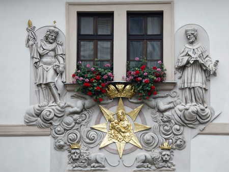 Prague, House of the Golden Well, Madonna and Child surrounded by saints on the facade of the house in Pragueの写真素材
