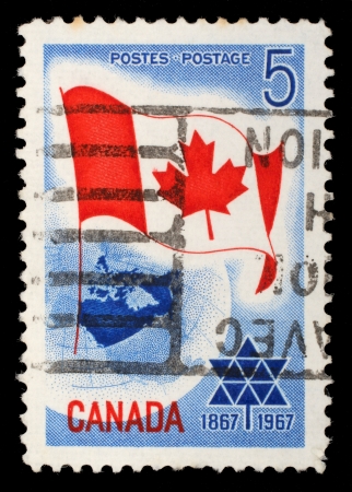 CANADA - CIRCA 1967: A stamp printed in Canada shows Canada flag, circa 1967のeditorial素材