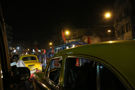 Dark city traffic blurred in motion at late evening on crowded streets on February 10, 2014 in Calcutta. Kolkata has a density of 814.80 vehicles per km road lengthのeditorial素材