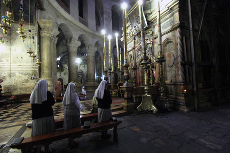 Early in the morning before the arrival of pilgrims from around the world, nuns praying in the...